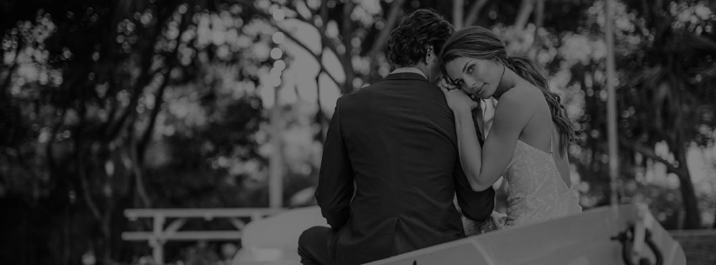 Silhouette of a couple sitting close together outdoors, black and white photo