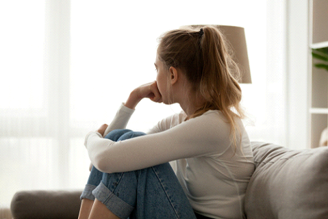 woman with separation anxiety sitting down, pausing and breathing